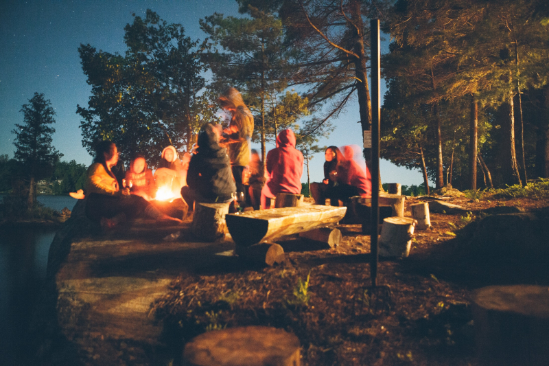 Photo by Tegan Mierle on Unsplash: https://unsplash.com/photos/group-of-people-near-bonfire-near-trees-during-nighttime-fDostElVhN8