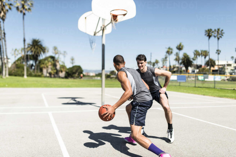 Photo by Lighteffect on Westend61 https://www.westend61.de/en/photo/LEF000121/two-young-men-playing-basketball-on-an-outdoor-court