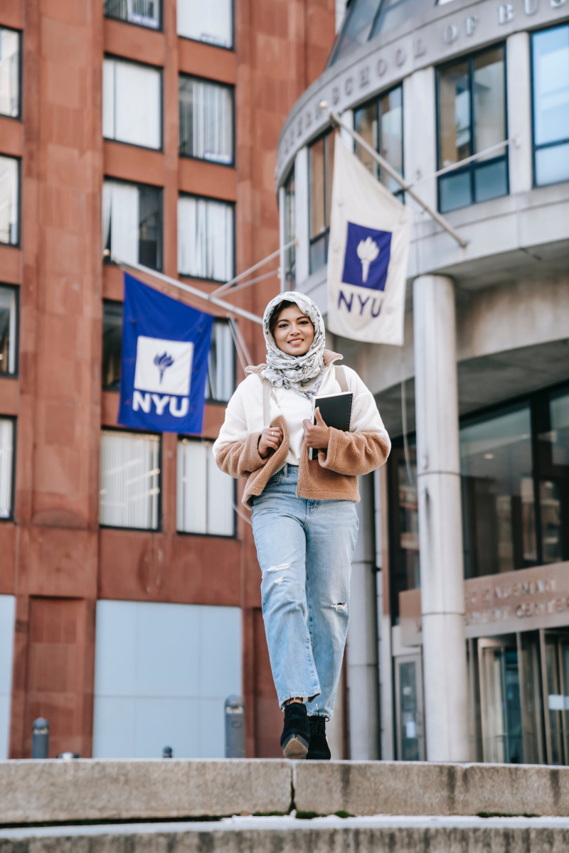 Photo by Keira Burton: https://www.pexels.com/photo/positive-muslim-female-student-standing-on-street-against-buildings-of-university-6084455/