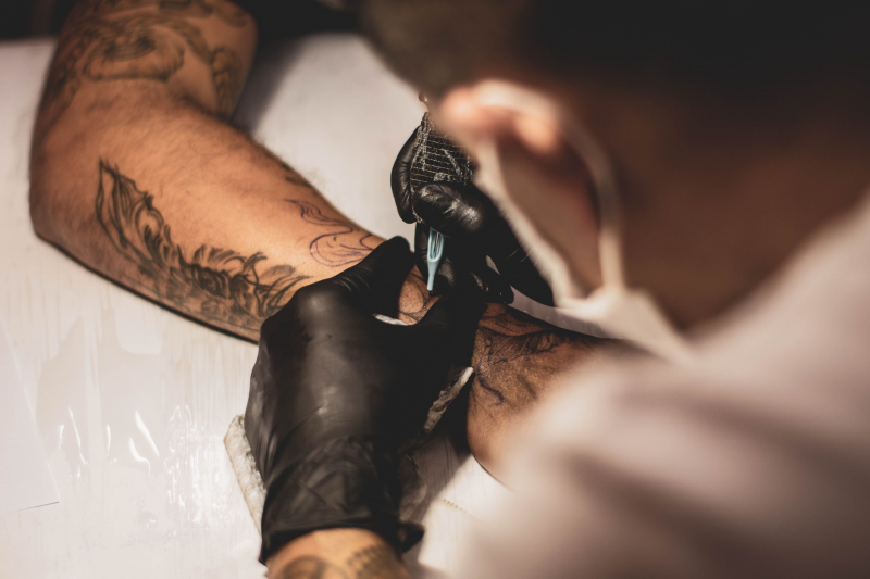 Photo by Lucas Lenzi on Unsplash: https://unsplash.com/photos/shallow-focus-photo-of-person-tattooing-persons-right-arm-zeT_i6av9rU