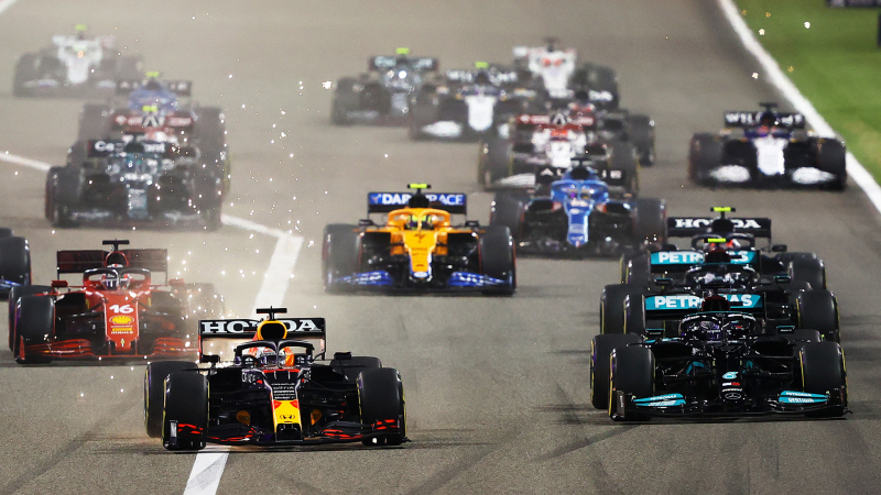 Racing cars compete on F1 road