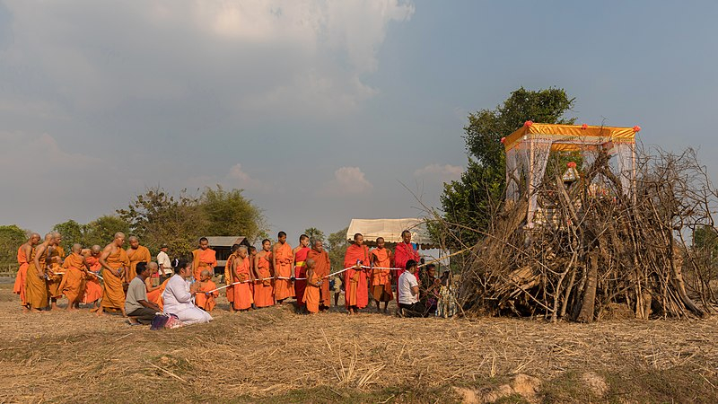 Photo on Wikimedia Commons (https://commons.wikimedia.org/wiki/File:Buddhist_monks_procession_in_front_of_a_pyre.jpg)