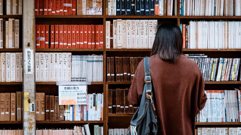 Photo by Abby Chung on Unsplash https://www.pexels.com/photo/woman-wearing-brown-shirt-carrying-black-leather-bag-on-front-of-library-books-1106468/