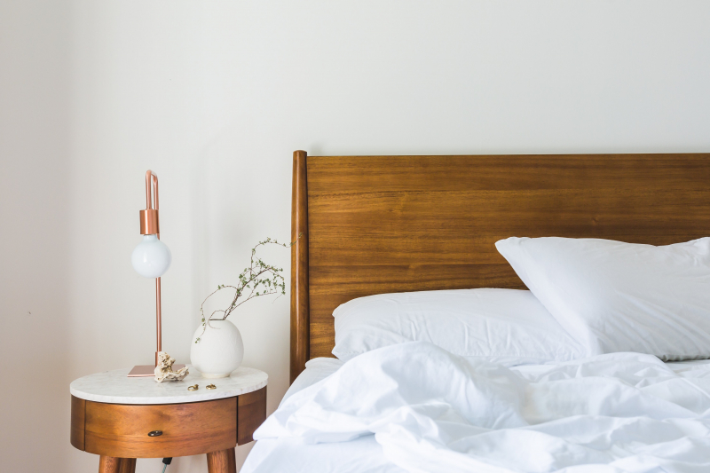 Photo by Burst: https://www.pexels.com/photo/white-bedspread-beside-nightstand-with-white-and-copper-table-lamp-545012/