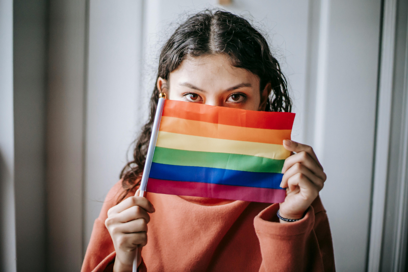 Photo by Tim  Samuel: https://www.pexels.com/photo/young-ethnic-woman-with-colorful-lgbt-flag-5845282/