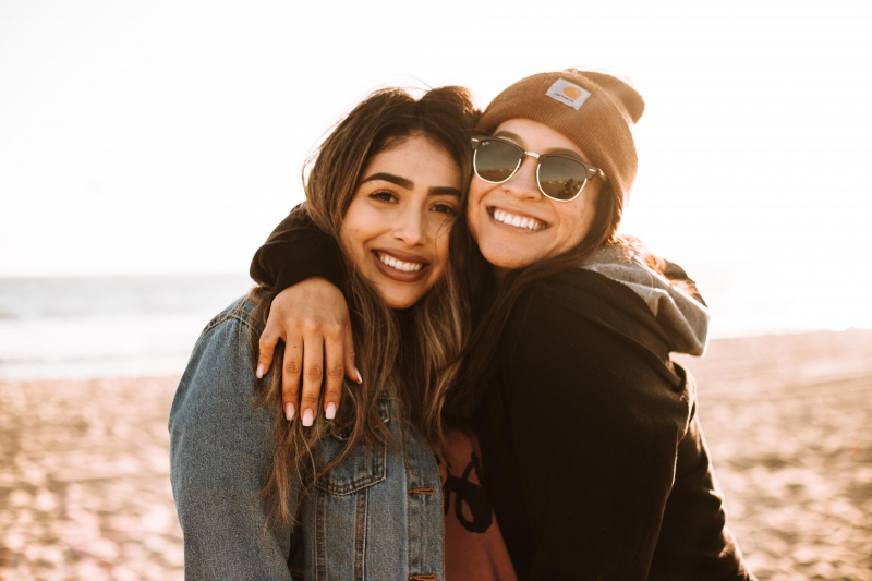 Photo by Omar Lopez on Unsplash: https://unsplash.com/photos/woman-hugging-other-woman-while-smiling-at-beach-0-uzdU3gUYw