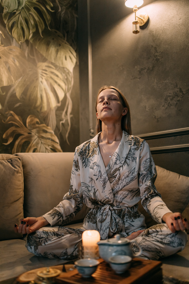 Photo by Ivan Samkov: https://www.pexels.com/photo/a-woman-sitting-on-the-couch-while-meditating-7162268/