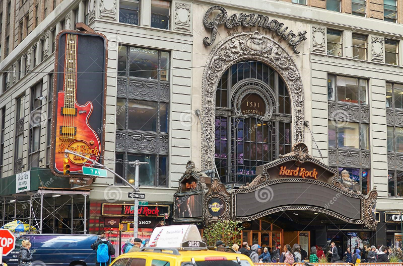NEW YORK CITY, MANHATTAN, OCT,25, 2013: View on NYC classic style office building with co-working offices. Paramount restaurant and Rock cafe with guitar decoration. Photo: Dreamstime