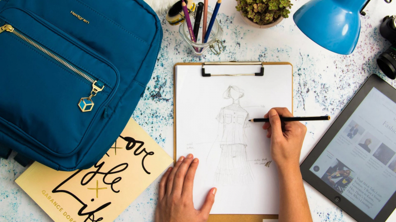 Photo by Ray Piedra on Pexels https://www.pexels.com/photo/person-sketching-dress-on-printer-paper-with-clip-board-1478477/