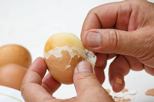 Removing hard-boiled egg shells immediately after cooking
