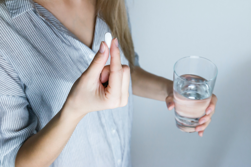Photo by JESHOOTS.com: https://www.pexels.com/photo/woman-holding-half-full-glass-and-white-medicine-pill-576831/