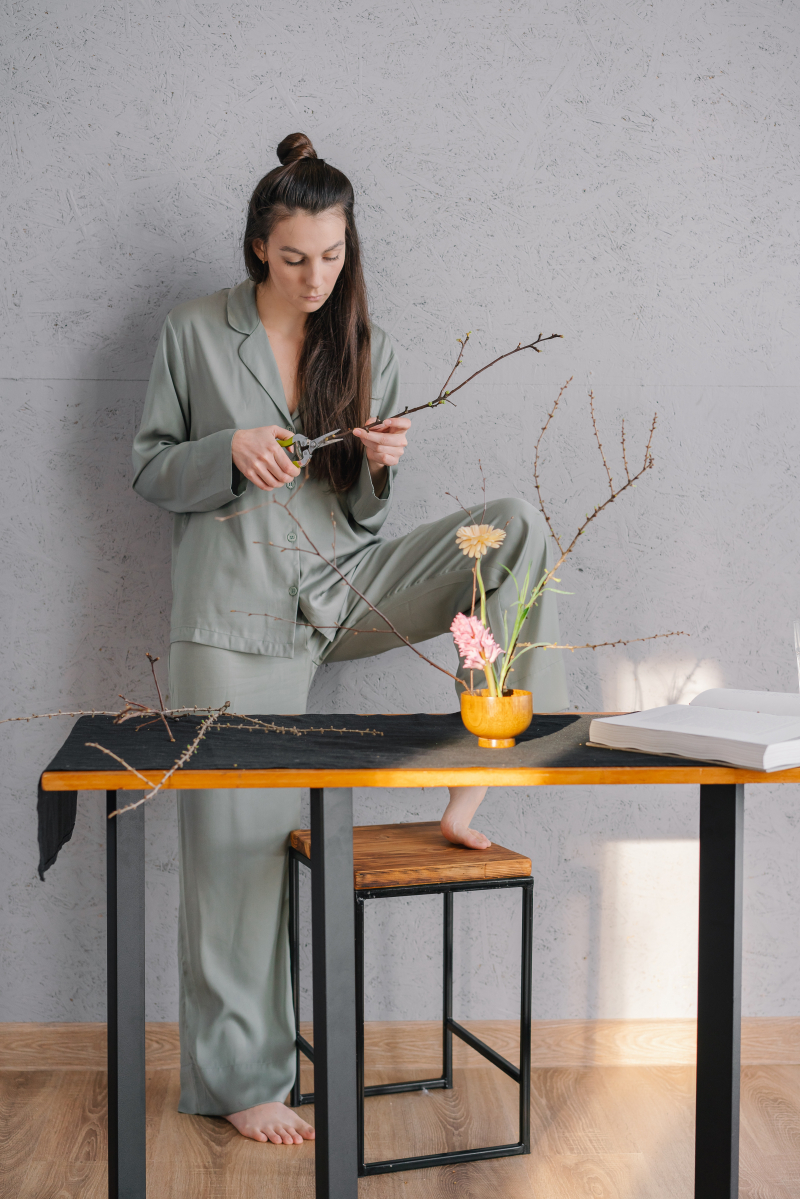 Photo by Mikhail Nilov: https://www.pexels.com/photo/a-woman-in-gray-pajama-arranging-a-homemade-decoration-6932589/