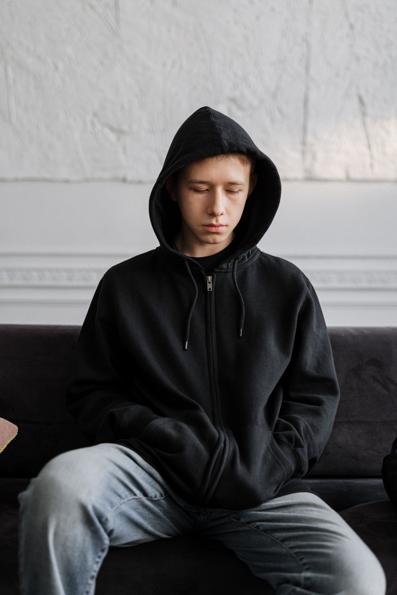 Photo by cottonbro studio: https://www.pexels.com/photo/man-in-black-hoodie-sitting-on-brown-couch-4100420/