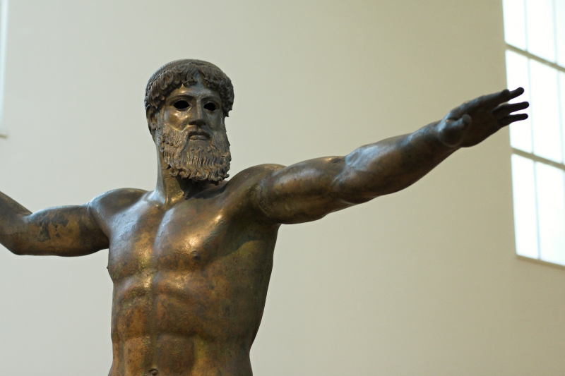 Greek mythological god Zeus - Photo on  Wikimedia Commons (https://commons.wikimedia.org/wiki/File:Zeus_or_Poseidon_bronze_460_BC,_NAMA_X_15161_102617.jpg)